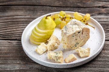 Piece of French Blue cheese grapes, honey and pear for dessert, Food recipe background. Close up