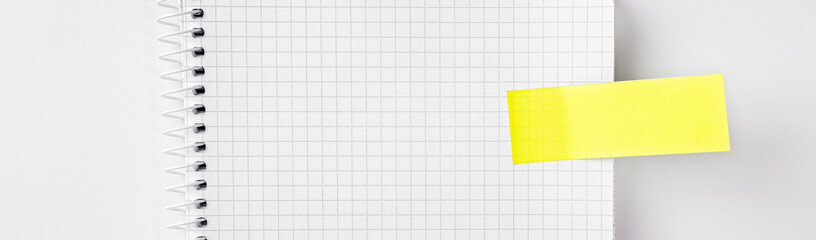 Checked notepad sheet with memo sticker, text and design