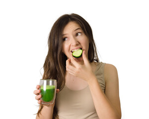 young beautiful woman drinking a cucumber green juice