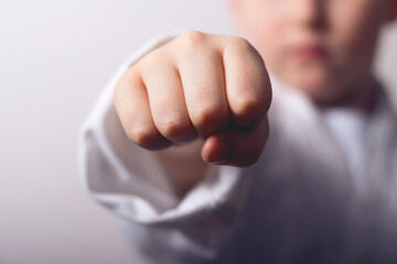 A young karate boy. Punch closeup