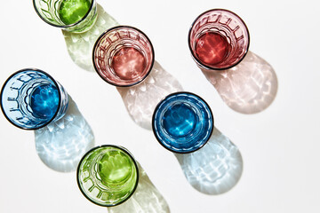 Colorful glasses in the sunlight with shadows.