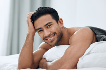 The bedroom is my happy place. Shot of a handsome young man lying on his bed.