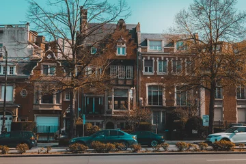 Foto op Plexiglas Brussels street with historic houses and passing cars. Belgian road. © depiano