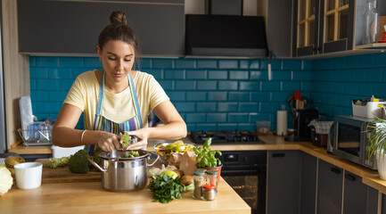 Young woman preparing broccoli for lunch