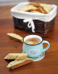 Vertical shot of a morning coffee with cantuccini bread on a wooden table