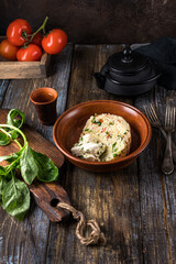 Plate of couscous with tomatoes, vegetables and feta cheese. Basil leaves, tomatoes, herbs and...