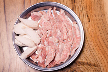 Raw pork on plate, Korean traditional style fresh pork beef belly BBQ, Japanese meat hot pot or Shabu in the restaurant, barbecue food