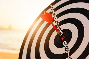 Dart arrow hitting to center on bullseye (bull's-eye) dartboard is the target of purpose challenge...