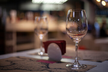 Empty glass of wine. Restaurant details. Dishes for alcohol. Set table.