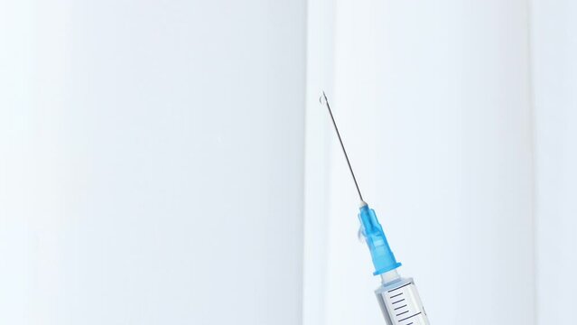Close Up of injection liquid being in syringe. Medication drug needle syringe drug, flu shot vaccine vial dose hypodermic injection treatment disease prevention immunization.