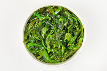 A bowl of pickled chukka. White background. Top view.