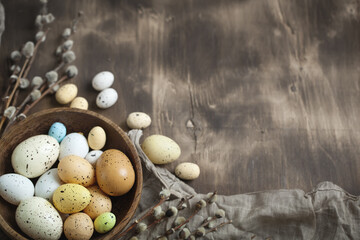 Congratulatory easter background. Easter eggs and flowers. Selective focus. Top view. Background with copy space.