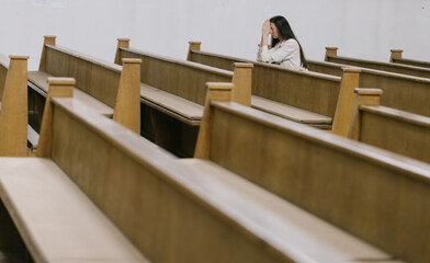 Woman praying to God in church