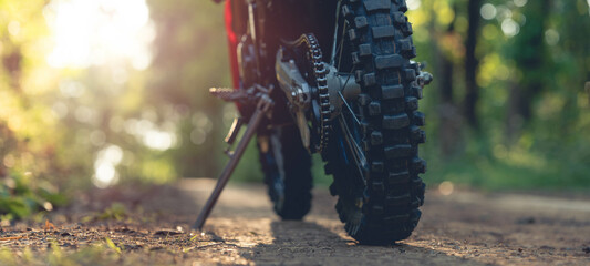 Part of a motocross wheel on a mound, with sunrise copyspace for your individual text. A part of a...