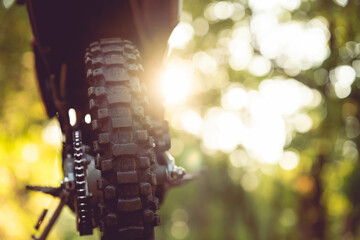 Part of a motocross wheel on a mound, with sunrise copyspace for your individual text. A part of a...