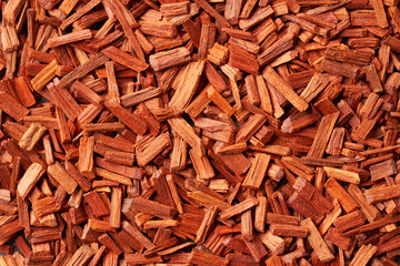 Background made of red sandalwood chips with copy space
