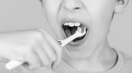 Little boy cleaning teeth with kids toothbrush. Dental hygiene. Little man brushing teeth. Happy child kid boy with toothbrush. Health care, dental hygiene