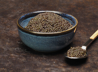 A small bowl of black lumpfish roe, a cheap caviar alternative