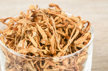 Dried cordyceps militaris mushroom flower on wooden background.