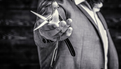 Vintage barbershop. Brutal guy, scissors, straight razor. Client visiting barber shop. Barber...