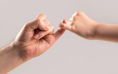 Friendship of generations. Father, daughter hand making promise friendship concept. Child hook little finger together. Little finger of the two hands hold together. Show friendship and forgiveness