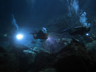 Divers in cenote Eden, Yucatan Peninsula, Mexico, underwater photograph 