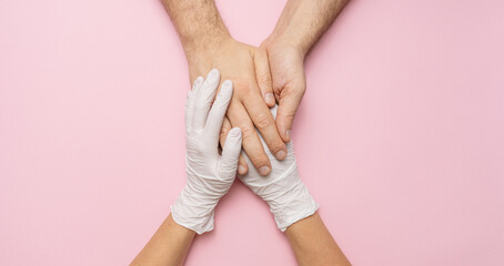 Fototapeta Doctor's hands holding woman hands in gloves. Medical banner wit obraz