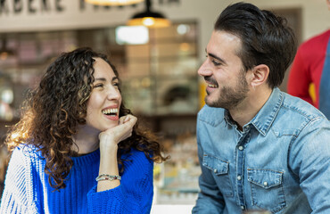 Happy couple of lover - Funny situation with both man and woman looking into each eyes - Relationship concept with boyfriend and girlfriend at first date