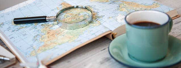 Fototapeta na wymiar Horizontal banner or header with planning world tour with vintage magnifying glass and travel map - Journey trends, globetrotter and holiday concept - Adventures in the world