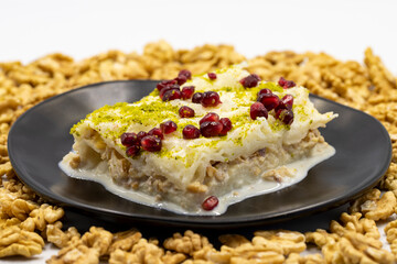 Gullac dessert. Traditional Turkish dessert sprinkled with walnuts. Gullac is a dessert made with milk. close up