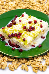 Gullac dessert. Traditional Turkish dessert sprinkled with walnuts. Gullac is a dessert made with milk. close up