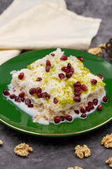 Gullac dessert ( milk dessert ) on a dark background. Traditional Turkish dessert. close up