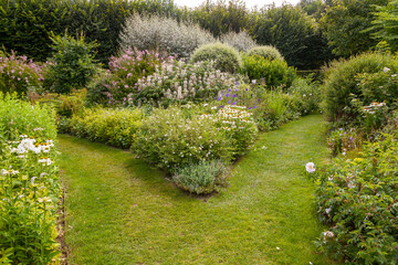 Parterres et massifs de fleurs entourées d'allée en pelouse dans un jardin botanique