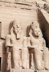 Two monumental statues at the front of the Great Temple of Ramses II, Abu Simbel Egypt
