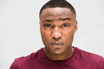 Close up young African american man with serious face expression staring