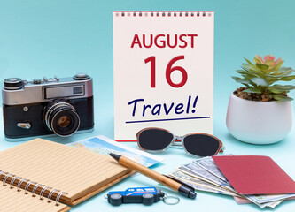 Travel planning, vacation trip - Calendar with the date 16 August glasses notepad pen camera cash passports.