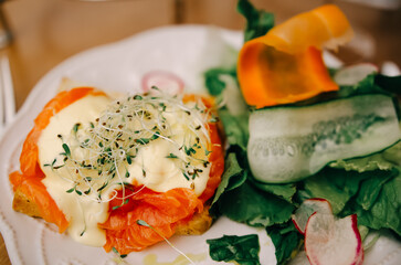 Morning breakfast with fresh toast with salmon and vegetables. Healthy food concept.