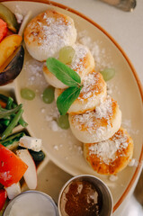Delicious cottage cheese pancakes for breakfast, along with a vegetable plate.