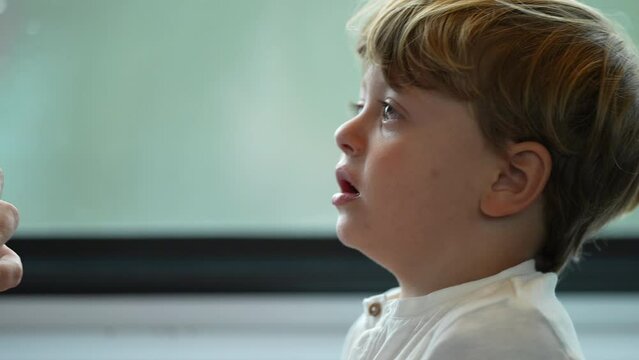 Tearful child listening to mother scolding him for misbehavior