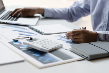 Businessmen use laptops to calculate budgets and analyze business profit growth. Financial planning and business accounting concepts.