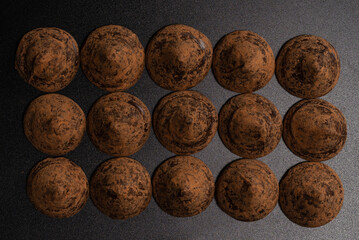 Chocolate truffles on a black background.