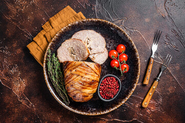 Baked delicious beef meatloaf, sliced meat loaf with bacon and herbs on a plate. Dark background....