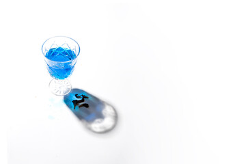 Cold butterfly pea flower drink  or blue tea on white background with beautiful shadow . Modern herbal beverage concept