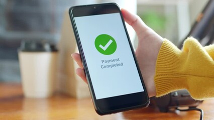 Customer sending bitcoin with smartphone for online payment at shop, close up of smartphone screen