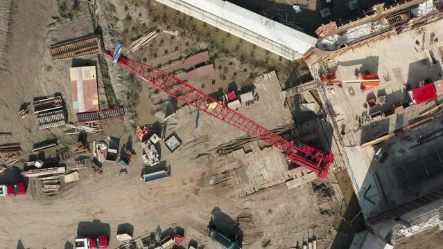 Aerial top down, crawler crane erected on foundation construction site