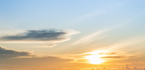Sunset sky clouds in the evening with orange sunlight on blue sky background