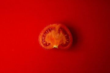 Red tomato on a red background