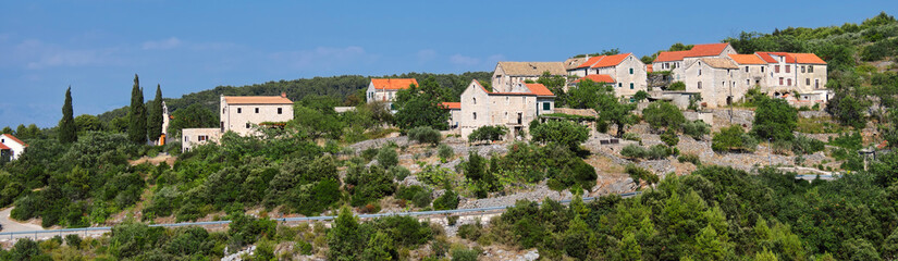 Fototapeta na wymiar Panoramic banner image of Hvar island in Croatia. Aerial view on mountains with old village. Bird view panoramic image taken from old mountain road in Hvar hills.