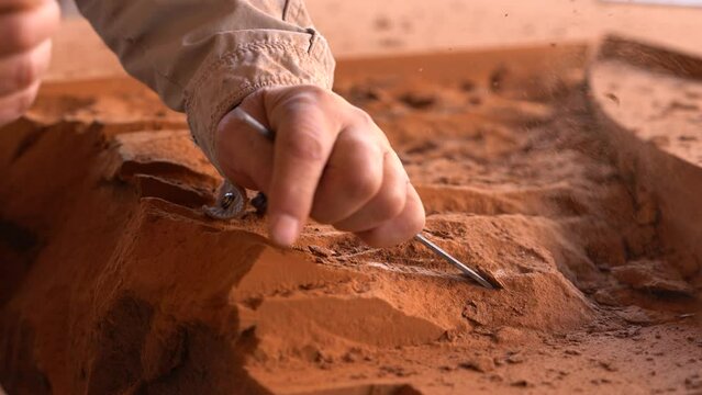 Craftsman hand working with stone. Stonemason working with his tools.  Sculptor working with chisel on stone. Carving stone, craftsman shaping stone, art and crafts. 