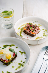 Smorrebrods, Danish open sandwich with salmon, egg, roast beef, sweet onions, avocado and cilantro sauce.